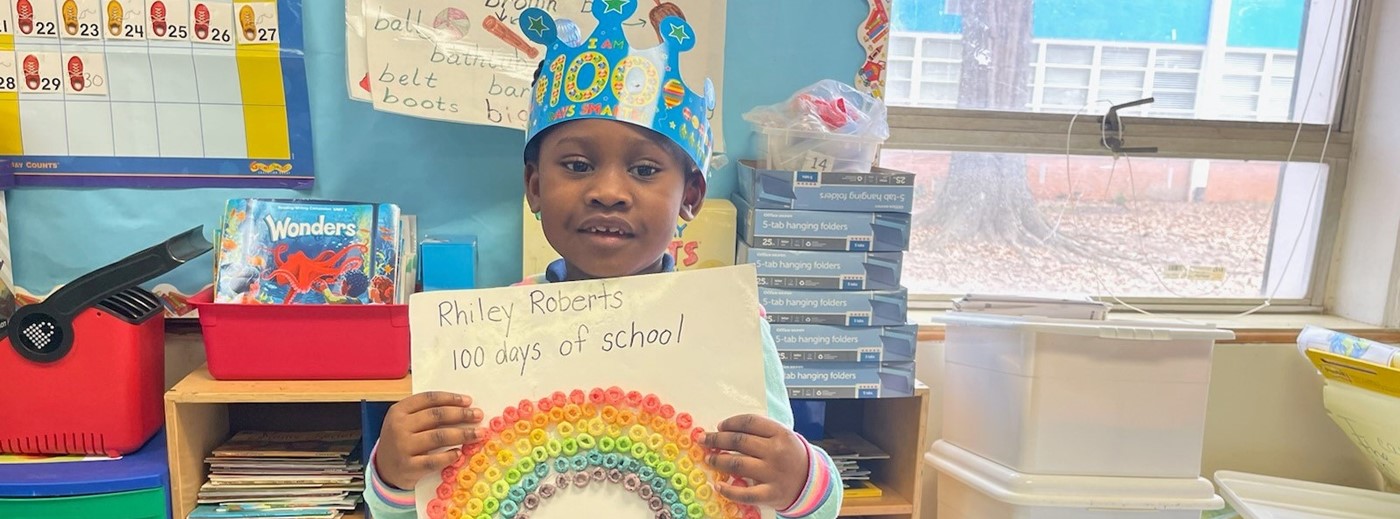 A kid showing her 100 Days of School activity